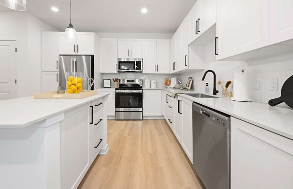 Modern kitchen with stainless steel appliances and island in Marlowe Gateway Apartments