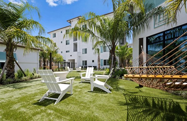 Patio with modern seating and lush greenery at Marlowe Gateway Apartments