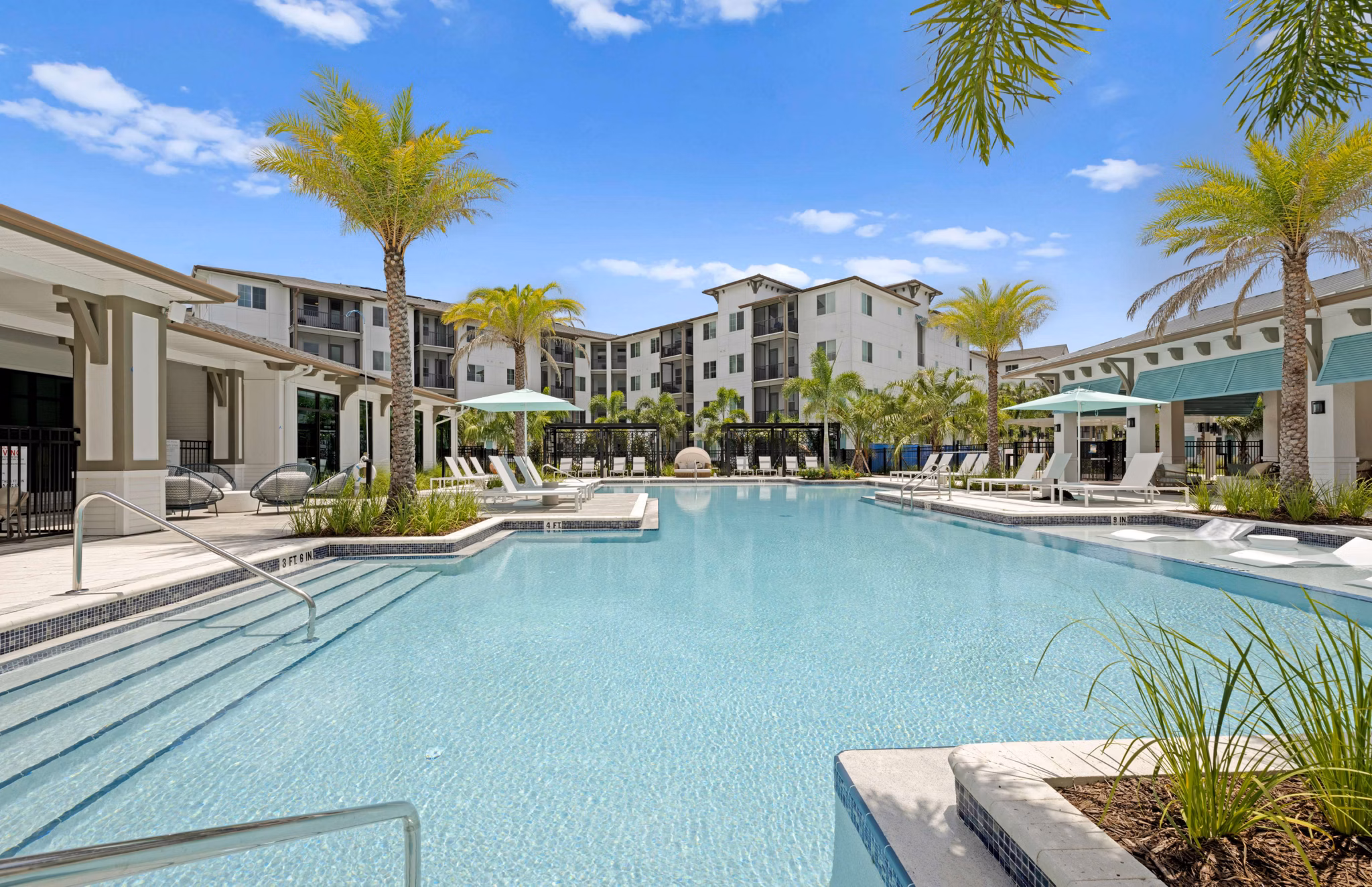 Resort-style pool with lounge chairs at Marlowe Gateway Apartments, ideal for relaxation and leisure in luxury living