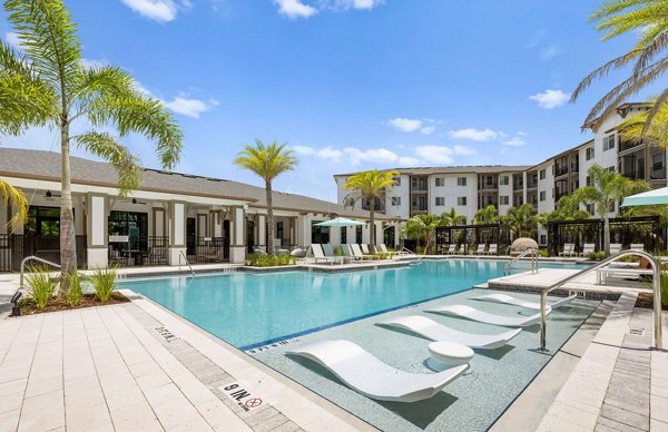 Marlowe Gateway Apartments: Lush outdoor pool area with modern lounge chairs