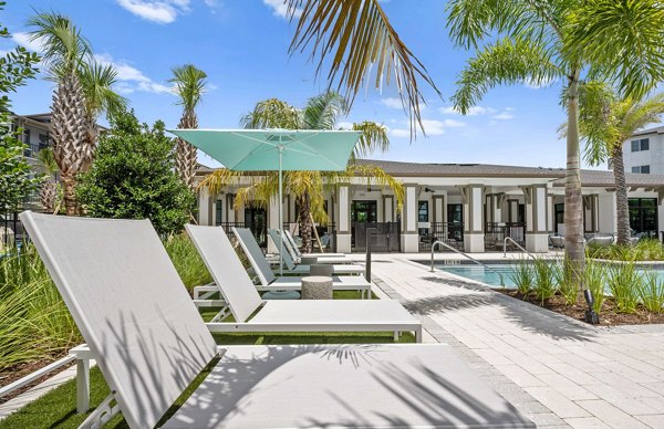 Pool with lounge chairs at Marlowe Gateway Apartments, a luxury community by Greystar