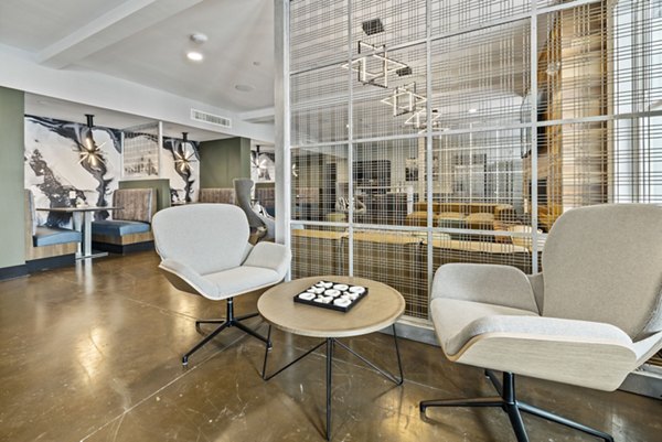 Contemporary clubhouse featuring modern decor and lounge areas at Apex Marathon Village Apartments