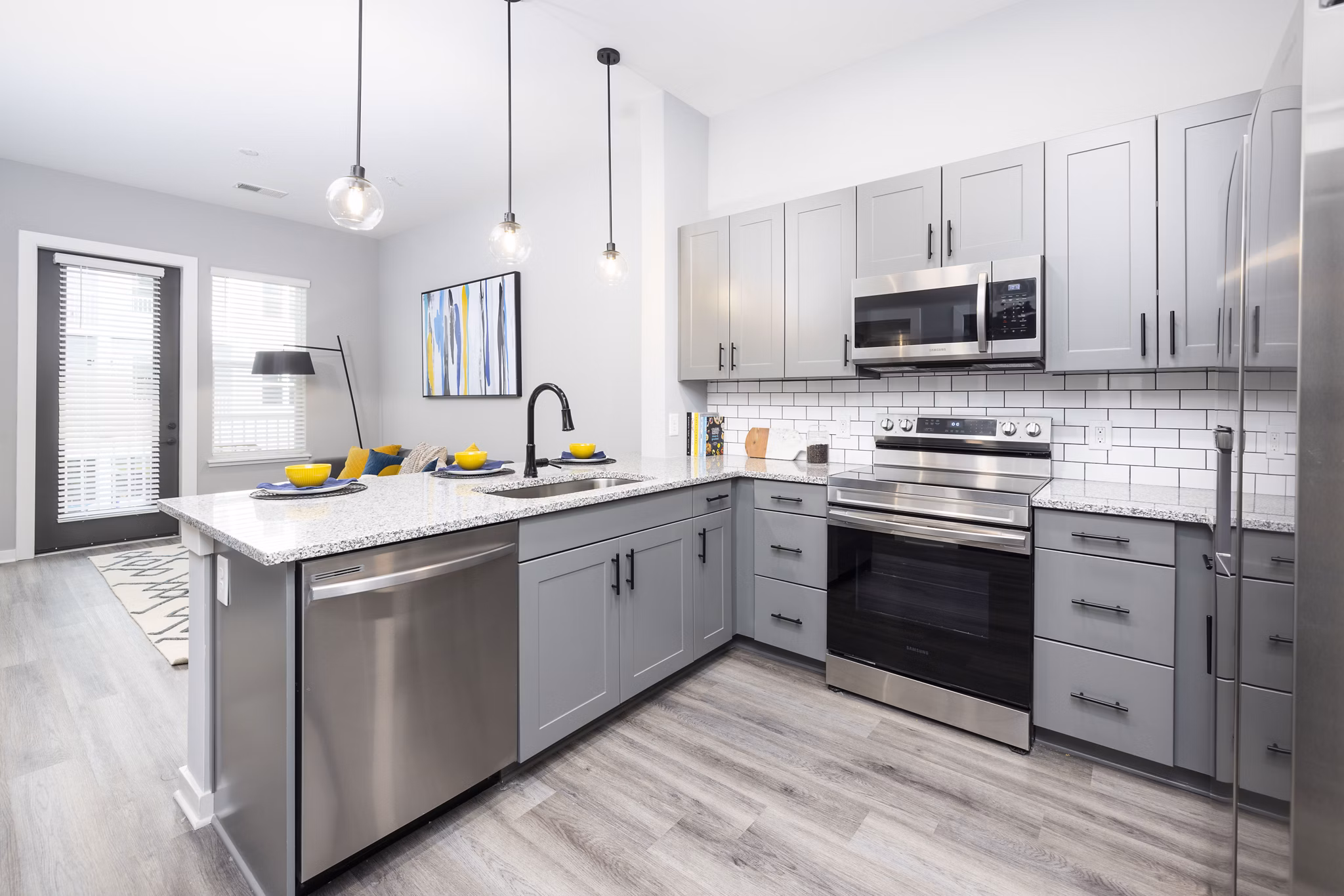 Modern kitchen featuring sleek appliances in Apex Marathon Village Apartments