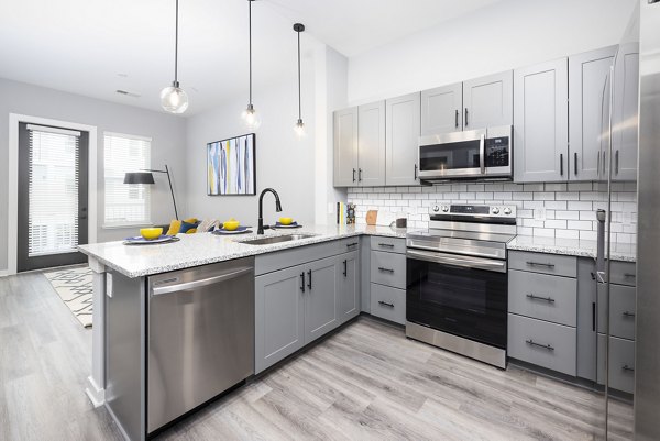 Modern kitchen featuring sleek appliances in Apex Marathon Village Apartments