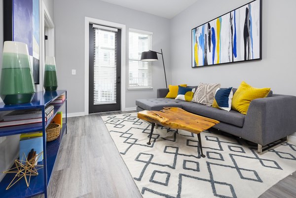 Spacious living room with modern decor in Apex Marathon Village Apartments