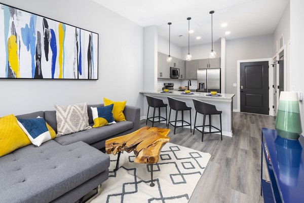 Contemporary living room with stylish decor and open layout at Apex Marathon Village Apartments