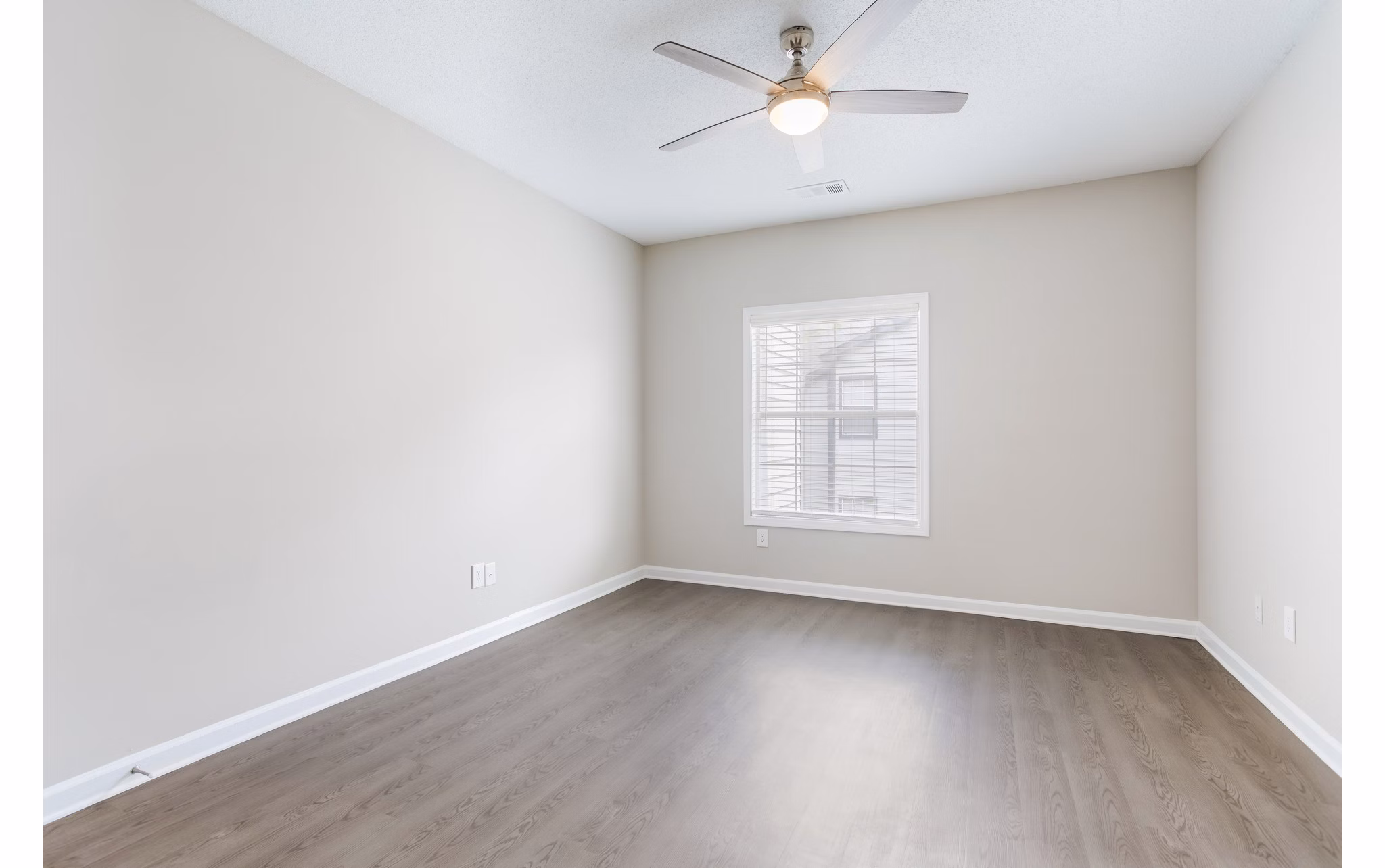 Spacious bedroom with natural light and modern decor at Ashton Brook Apartments