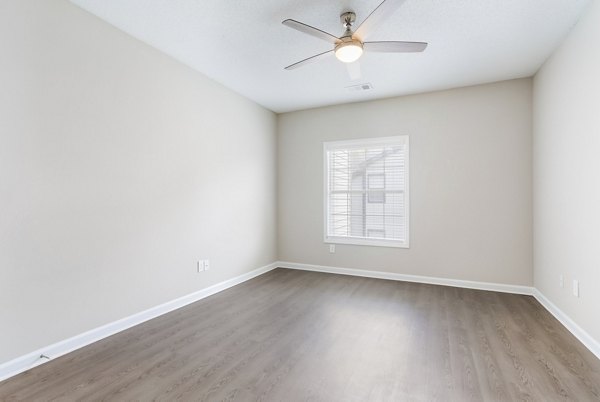 Spacious bedroom with natural light and modern decor at Ashton Brook Apartments
