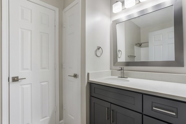 Elegant bathroom with marble countertops at Ashton Brook Apartments