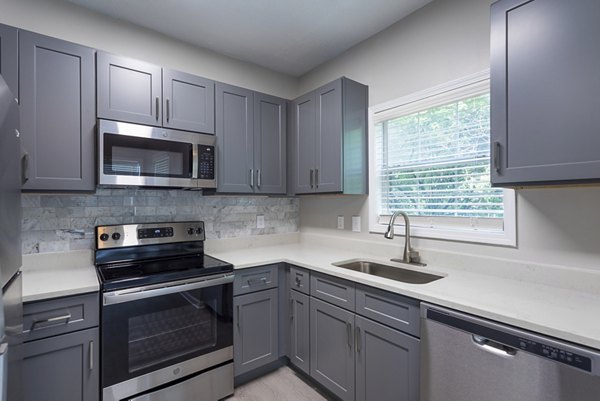 Modern kitchen with sleek countertops and stainless steel appliances in Ashton Brook Apartments