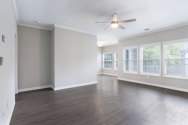 Living room at Ashton Brook Apartments: Cozy interior with modern furnishings and ample natural light in luxury Greystar property