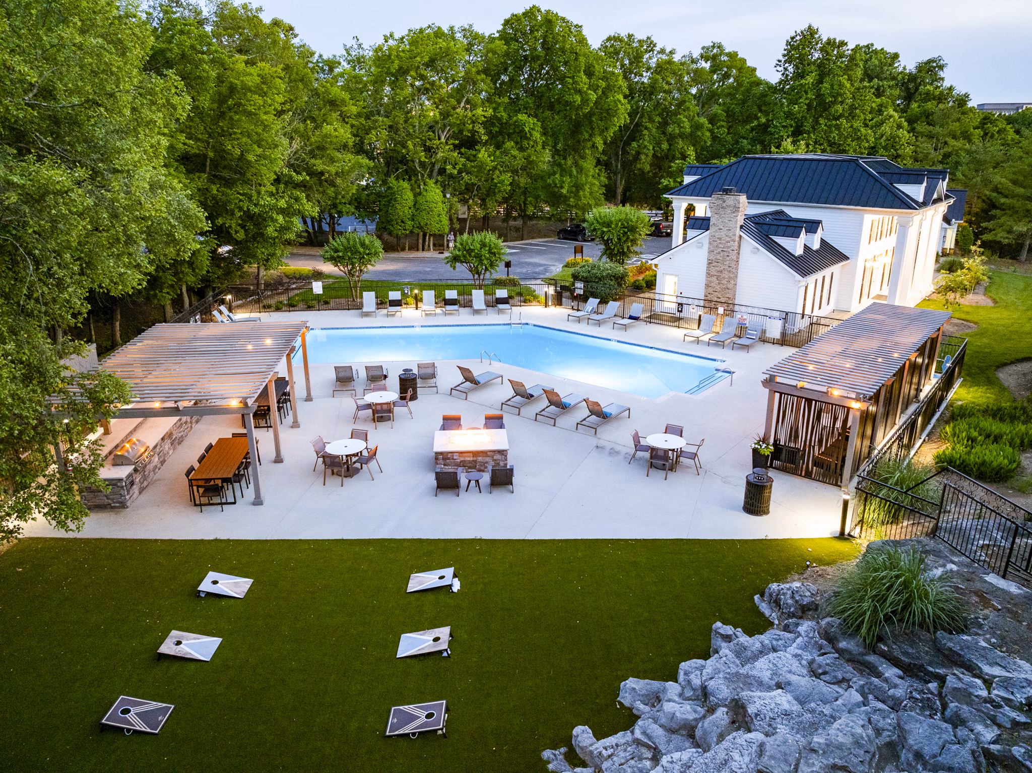 Outdoor pool area with sun loungers at Ashton Brook Apartments, offering a luxury lifestyle