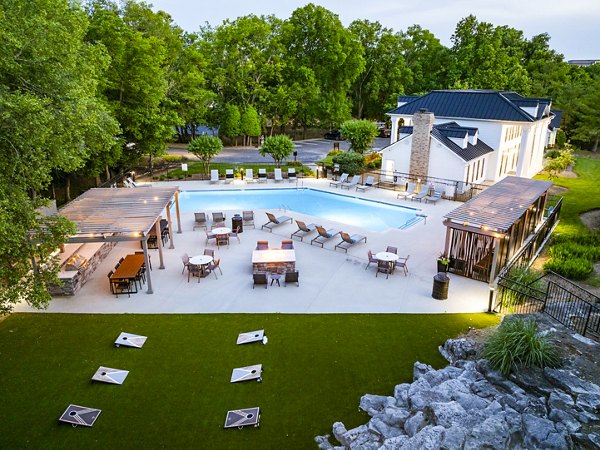 Outdoor pool area with sun loungers at Ashton Brook Apartments, offering a luxury lifestyle