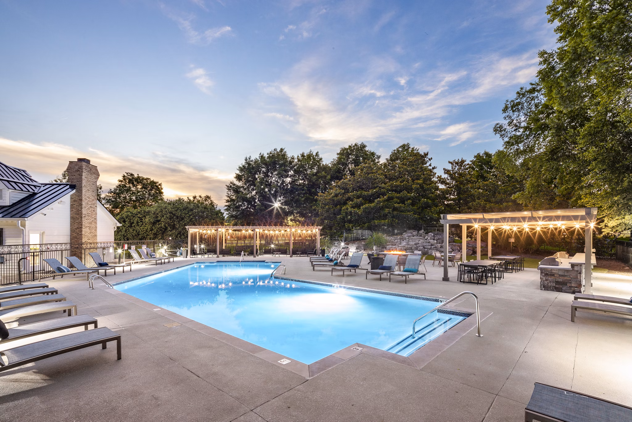 Luxurious outdoor pool with lush landscaping at Ashton Brook Apartments in a serene setting