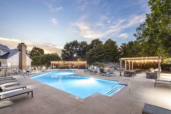 Luxurious outdoor pool with lush landscaping at Ashton Brook Apartments in a serene setting
