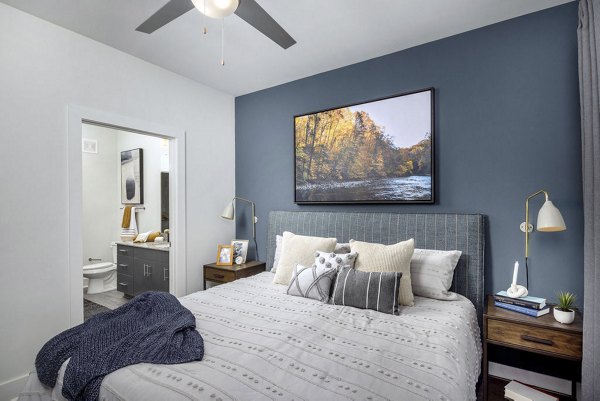 Bedroom with cozy decor and large windows at Prose Cartersville Apartments, offering comfort and style in luxury living