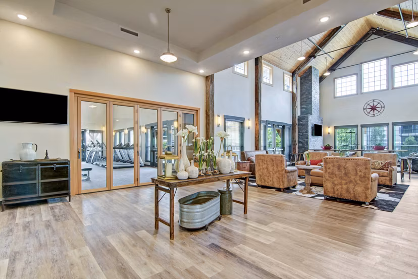 Clubhouse featuring cozy seating and modern decor at Seasons at Farmington Reserve Apartments, perfect for luxury gatherings and relaxation