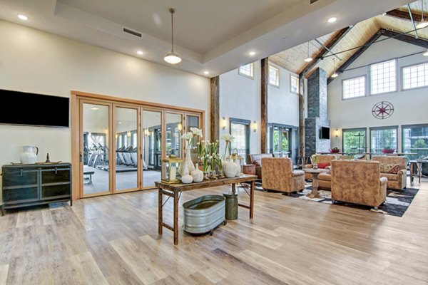 Clubhouse featuring cozy seating and modern decor at Seasons at Farmington Reserve Apartments, perfect for luxury gatherings and relaxation