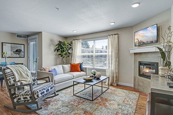 Spacious living room with modern furnishings and large window at Seasons at Farmington Reserve Apartments Perfect for stylish luxury living