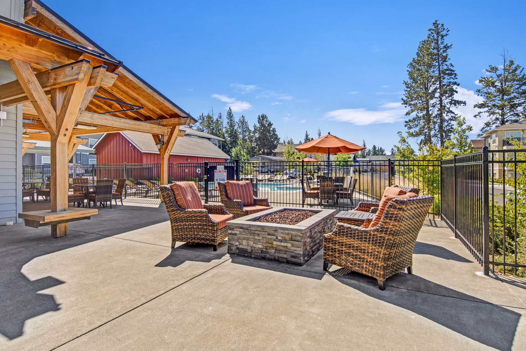 Fire pit on patio at Seasons at Farmington Reserve Apartments, offering cozy outdoor seating in a luxury setting