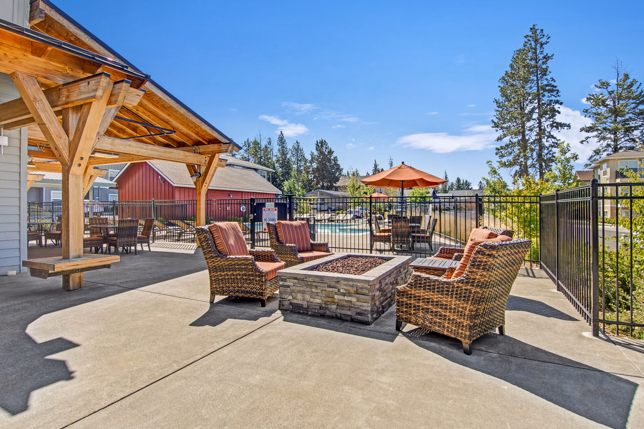 Fire pit on patio at Seasons at Farmington Reserve Apartments, offering cozy outdoor seating in a luxury setting