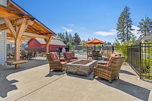 Fire pit on patio at Seasons at Farmington Reserve Apartments, offering cozy outdoor seating in a luxury setting