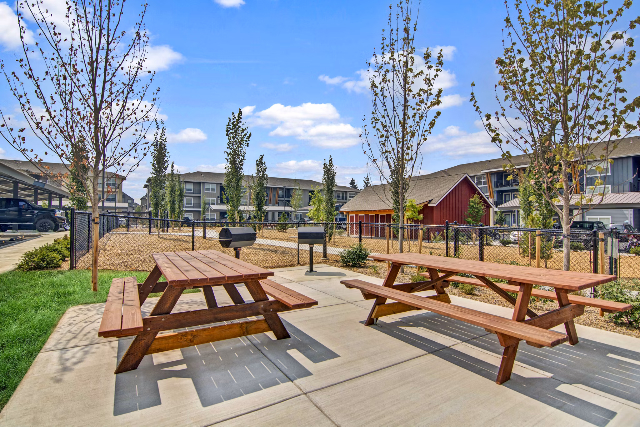 Grill area patio at Seasons at Farmington Reserve Apartments offering outdoor cooking and dining options