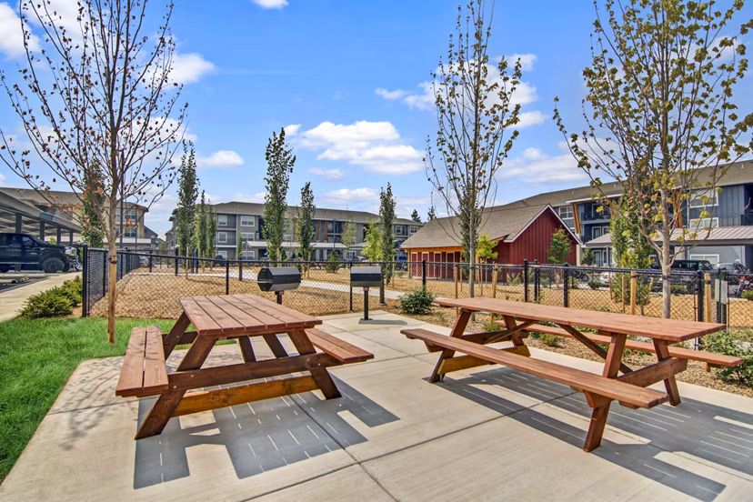 Grill area patio at Seasons at Farmington Reserve Apartments offering outdoor cooking and dining options
