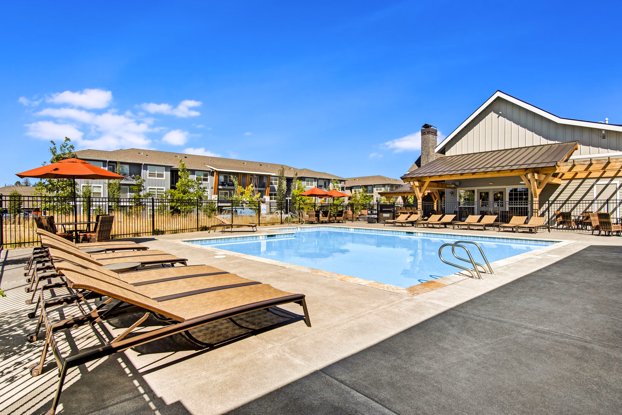 Tranquil poolside seating at Seasons at Farmington Reserve Apartments, perfect for relaxation and luxury living