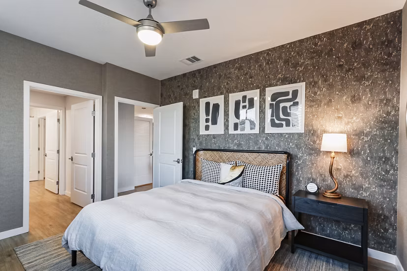 Cozy bedroom with elegant decor at Jefferson La Mesa Apartments featuring luxurious furnishings and ample lighting for modern living