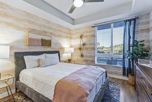 Cozy bedroom with elegant decor at Jefferson La Mesa Apartments featuring luxurious furnishings and ample lighting for modern living