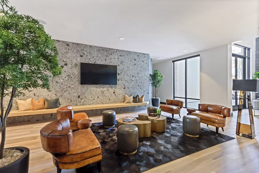 Clubhouse meeting facility with modern seating and tech amenities at Jefferson La Mesa Apartments