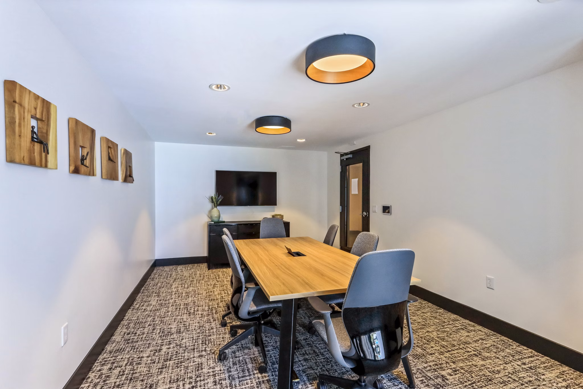 Clubhouse meeting facility with modern seating and tech amenities at Jefferson La Mesa Apartments