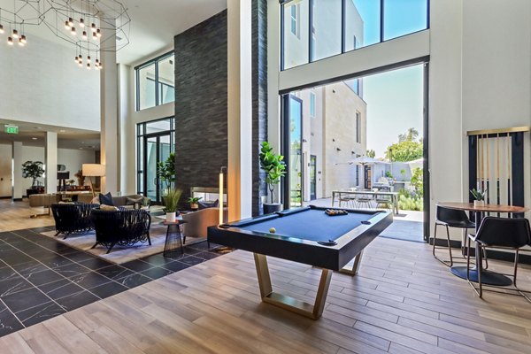 Clubhouse game room with billiards and lounge seating at Jefferson La Mesa Apartments