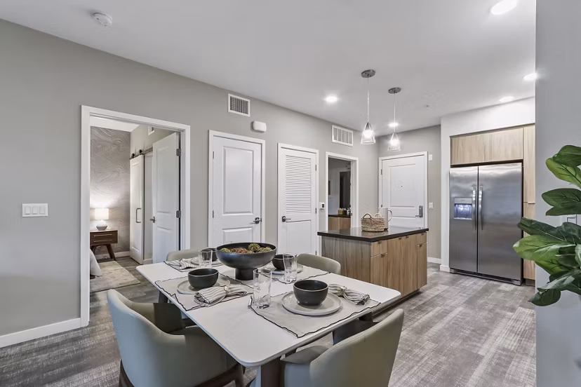 Dining room with elegant lighting and modern furnishings at Jefferson La Mesa Apartments, offering a sophisticated dining experience