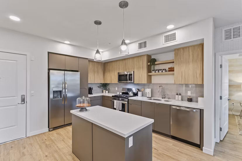 Modern kitchen with stainless steel appliances and granite countertops at Jefferson La Mesa Apartments
