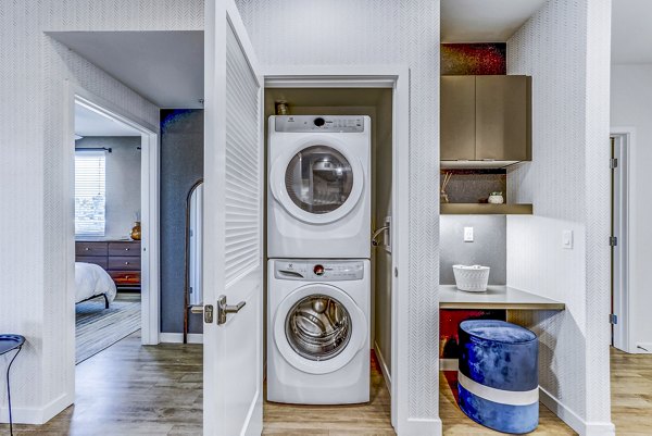 Laundry room with modern washers and dryers at Jefferson La Mesa Apartments, offering convenience and efficiency for residents