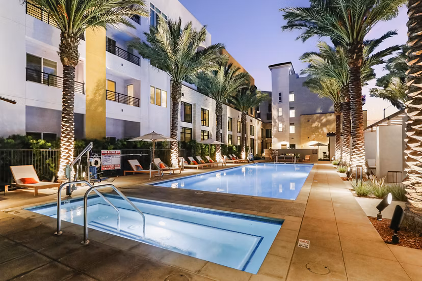Sparkling outdoor pool at Jefferson La Mesa Apartments with luxurious lounge chairs and landscaped surroundings