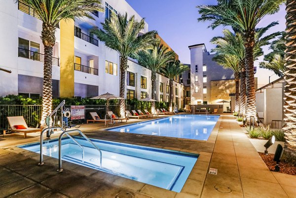 Modern pool with lounge chairs at Jefferson La Mesa Apartments, luxury living in a serene environment