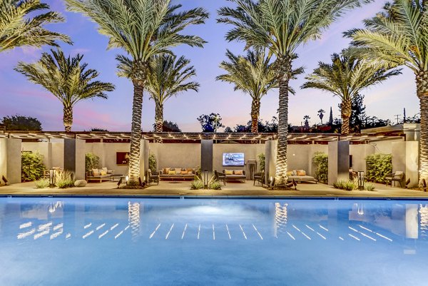 Modern outdoor pool with lounge chairs at Jefferson La Mesa Apartments