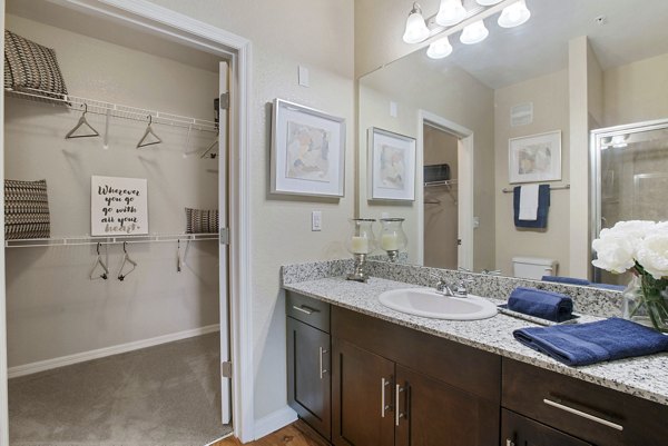 Contemporary bathroom with deep closet space at Integra Lakes Apartments