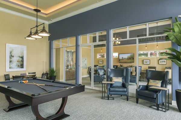 Game room with pool table and vibrant artwork in luxury apartment community