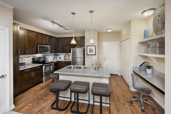 Modern kitchen with stainless steel appliances at Integra Lakes Apartments