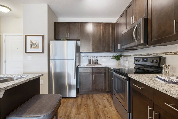 Modern kitchen with stainless steel appliances in Integra Lakes Apartments