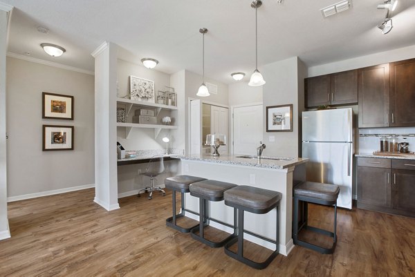 Modern kitchen with stainless steel appliances at Integra Lakes Apartments