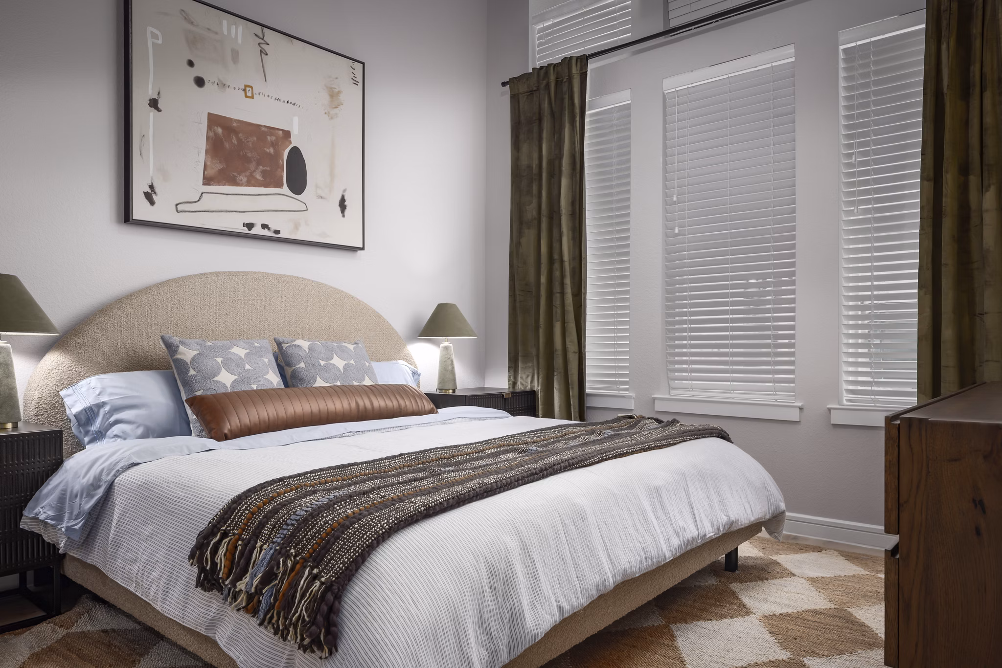 Cozy bedroom with modern design and ample natural light at The Ludlow Apartments