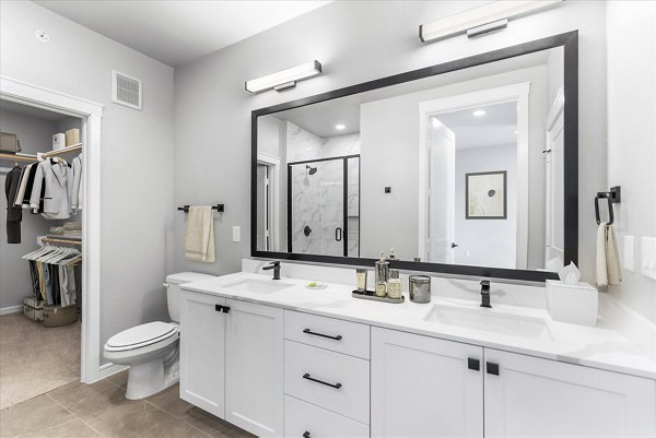 Modern bathroom with sleek fixtures and porcelain tiles at The Ludlow Apartments