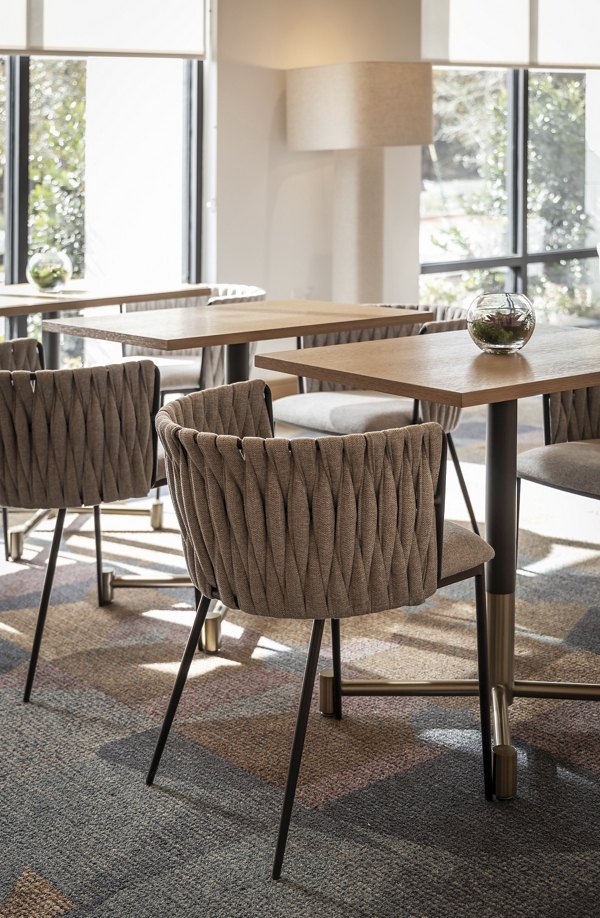 Clubhouse featuring modern decor and seating at The Ludlow Apartments