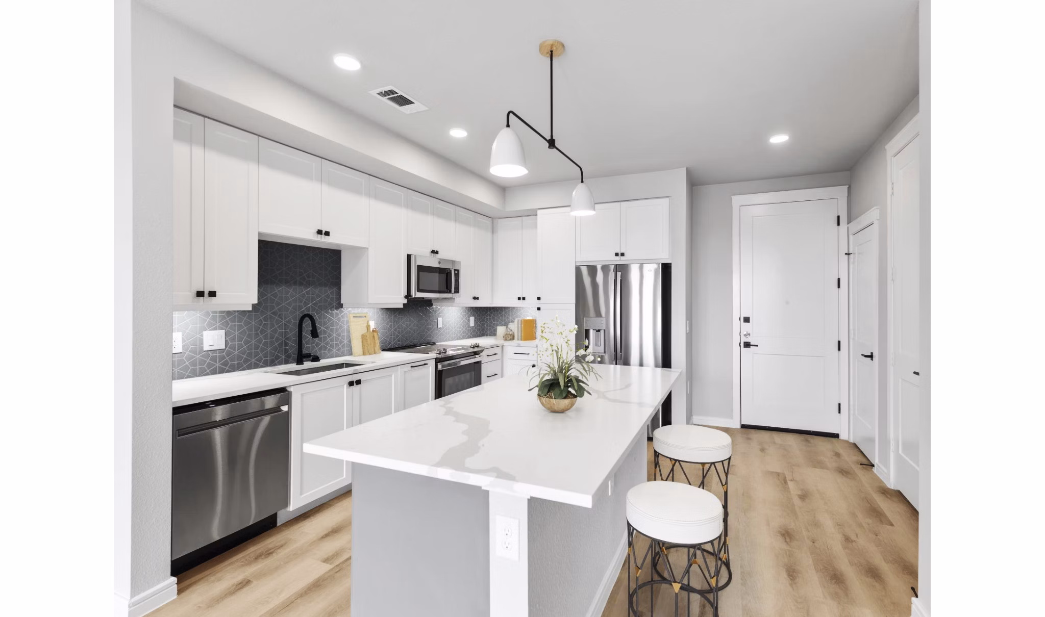 Modern kitchen with stainless steel appliances in The Ludlow Apartments luxury units
