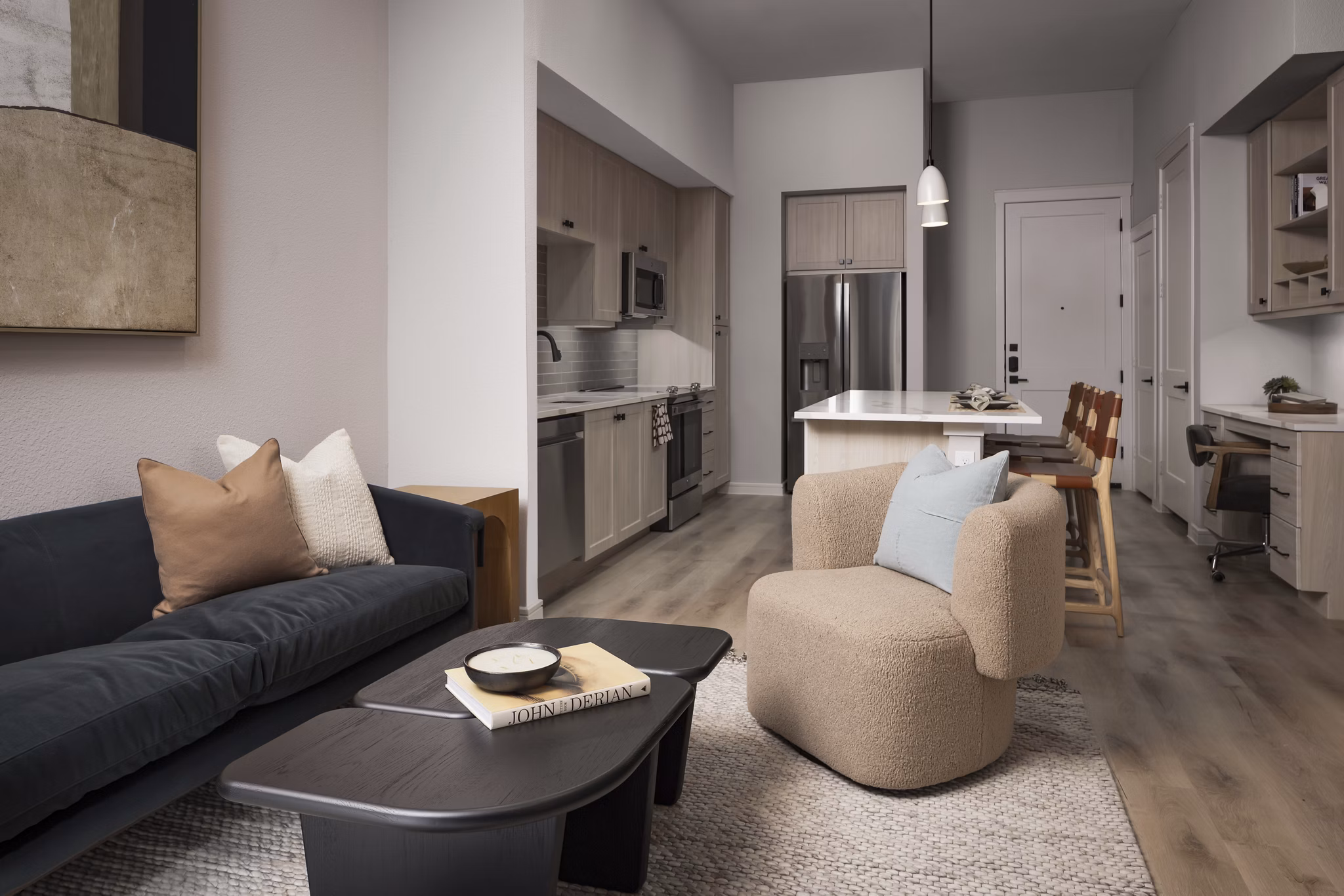 Spacious living room with modern decor and ample natural light at The Ludlow Apartments, a Greystar luxury property